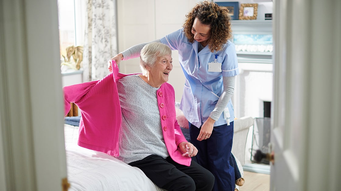 Aide Brushing Patient's Hair